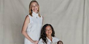 Ashleigh Raper (standing) carried baby Mia as a surrogate for her best friend,Lucy Koops.