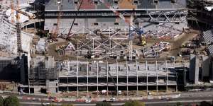 Suncorp Stadium under construction in 2002,with the existing western stand at the rear.