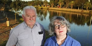 John Guegan and Madeleine Serle,whose homes were flooded last October,next to the Maribyrnong River on Friday.