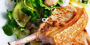 Pan-fried pork cutlets with apple,fennel and radish salad.