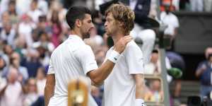 Novak Djokovic and Andrey Rublev embrace after their Wimbledon quarter-final.
