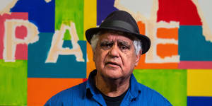 Artist Richard Bell in front of one of his paintings in a scene from the documentary You Can Go Now.