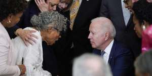 US President Joe Biden listens to 94-year-old activist Opal Lee after signing the Jbill. 