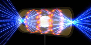 A target pellet inside a hohlraum capsule with laser beams entering through openings on either end. The beams compress and heat the target to the necessary conditions for nuclear fusion to occur.