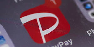 The PayPay app icon on a smartphone in Tokyo,
