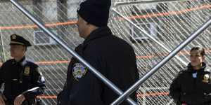 Police officers behind security fences outside the office of Manhattan District Attorney Alvin Bragg.