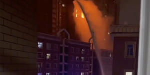 In this image taken from video,firefighters spray water on a fire at a residential building in Urumqi in western China’s Xinjiang region.