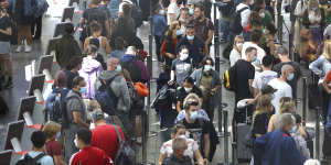 Domestic passengers endure long queues at Sydney Airport early on Saturday afternoon.