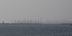 The view across Port Phillip Bay from Brighton on Sunday as haze lingered over Melbourne.