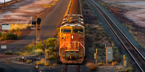 A BHP train carries iron ore to Port Hedland. The miner relies on China for half its revenue.