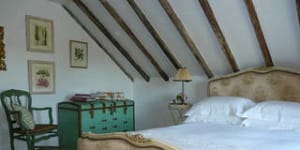 Simply French...exposed timber beams in the bedroom.