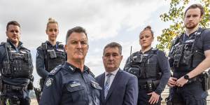 Acting Commissioner Bob Hill (centre) and Detective Inspector Michael Daly and Viper officers.