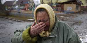 A woman cries outside houses damaged by a Russian airstrike in Gorenka,outside the capital Kyiv,Ukraine.