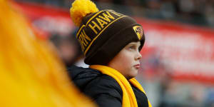 A young Hawthorn fan watches a match in Hobart last year.