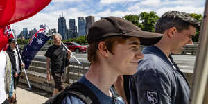 Pro-Australia Day protesters,including white supremacist Jacob Hersant (outer right),marching towards Melbourne Park.