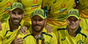 Glen Maxwell,captain Adam Finch and Steve Smith with the Chappell-Hadlee trophy in Cairns.
