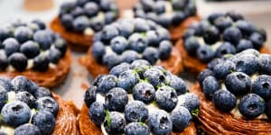 Blueberry tarts topped with a generous amount of berries.