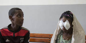 Kemal Abagojam,15,sits next to his mother Abagojam,who has just come out of trachiasis surgery at Seka Chekorsa Primary Hospital.