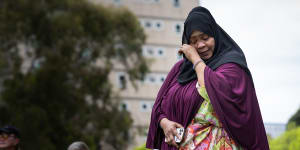 Public housing resident Aisha Abdi addresses the rally on Saturday.