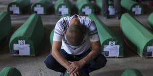 A man mourns next to the coffin of his relative,a victim of the 1995 Srebrenica genocide,in Potocari,Bosnia on Sunday.