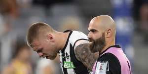 Jordan De Goey of the Magpies leaves the field under the blood rule on Friday night.