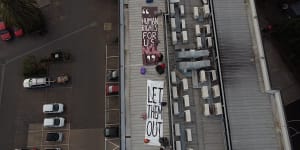 Refugee activists protest on the rooftop of the Preston hotel