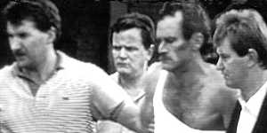 Russell"Mad Dog"Cox,second from right,following his capture at Melbourne's Doncaster shopping centre in 1988. 