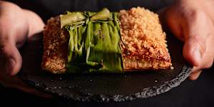 Hotel Canberra’s Stables Cafe&Bar lechon paksiw pie topped with pork crackling crumble and wrapped in banana leaf.
