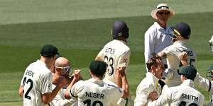 All in this together:Australia celebrate Nathan Lyon’s defeat of Ben Stokes.