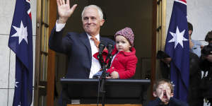 Malcolm Turnbull waves goodbye at the end of his final press conference as prime minister,with granddaughter Alice and grandson Jack. 