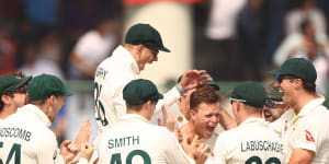 Todd Murphy leaps with joy after Matt Kuhnemann claims Virat Kohli for a maiden Test wicket.