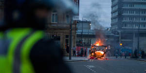 A police car is set on fire as far-right activists rally in Sunderland,England. 