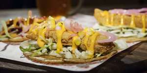 Fish tacos drizzled with sriracha mayo.