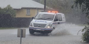 Two cops rescued after police car swept away in north Queensland floods