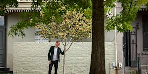 Thami Croeser demonstrates how the street trees on Canning Street in Carlton are failing to thrive,compared with the established trees in Carlton Gardens.