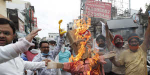 Indians in Lucknow burn an effigy of Chinese President Xi Jinping during a protest against the Chinese government on June 17 following clashes on the Himalayan border. 