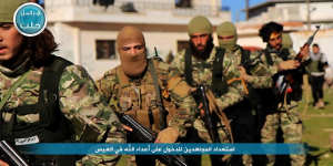 Nusra Front fighters marching toward the village of al-Ais in Aleppo,Syria,in April.