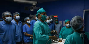 A specialist removes mucormycosis from a recovering COVID patient in Allahabad,India. 