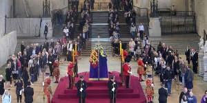 Members of the public file past the Queen’s coffin in Westminster Hall.