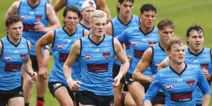 Nik Cox (centre) in action during an early pre-season running session.