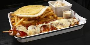 Chicken skewer with cheese,arepa (corn flatbread),chips and sweet cabbage. 