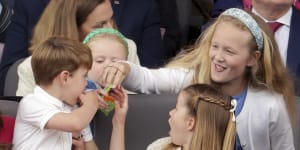 Prince Louis,Princess Charlotte and Savannah Phillips eat sweets,during the Platinum Jubilee Pageant held outside Buckingham Palace,in London.