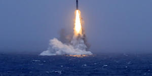 An image published by a Chinese state media outlet shows a missile being launched from a submarine in the South Pacific.