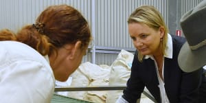 Sussan Ley (centre) as environmental minister with Greening Australia staff Kathleen Ward and David Warren sort paper daisy seeds at one of the group’s facilities near the Hawkesbury River in western Sydney. 