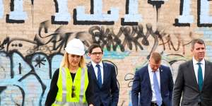 NSW Premier Mike Baird (right) arrives at the goods yard in Rozelle on Thursday to announce the extension.