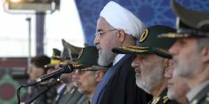 President Hassan Rouhani reviews a military parade marking 39th anniversary of outset of Iran-Iraq war,outside Tehran on Sunday.