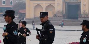 Security personnel on patrol outside a mosque attended by Uighurs in Xinjiang.