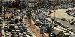 Lebanese families sit in a traffic jam as they flee southern villages amid Israeli airstrikes.
