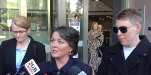Sarah Monaghan (centre) after the State Parole Authority hearing for convicted paedophile Robert Hughes.