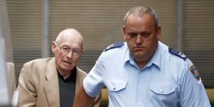 Roger Rogerson is escorted from court during his trial for the murder of Jamie Gao.